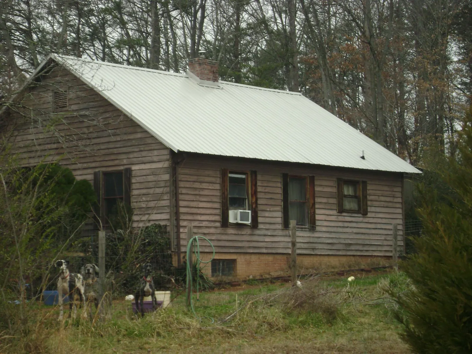 White metal roof on an old wood sided farmhouse, from a Metal Roof Installation job in Croton Falls